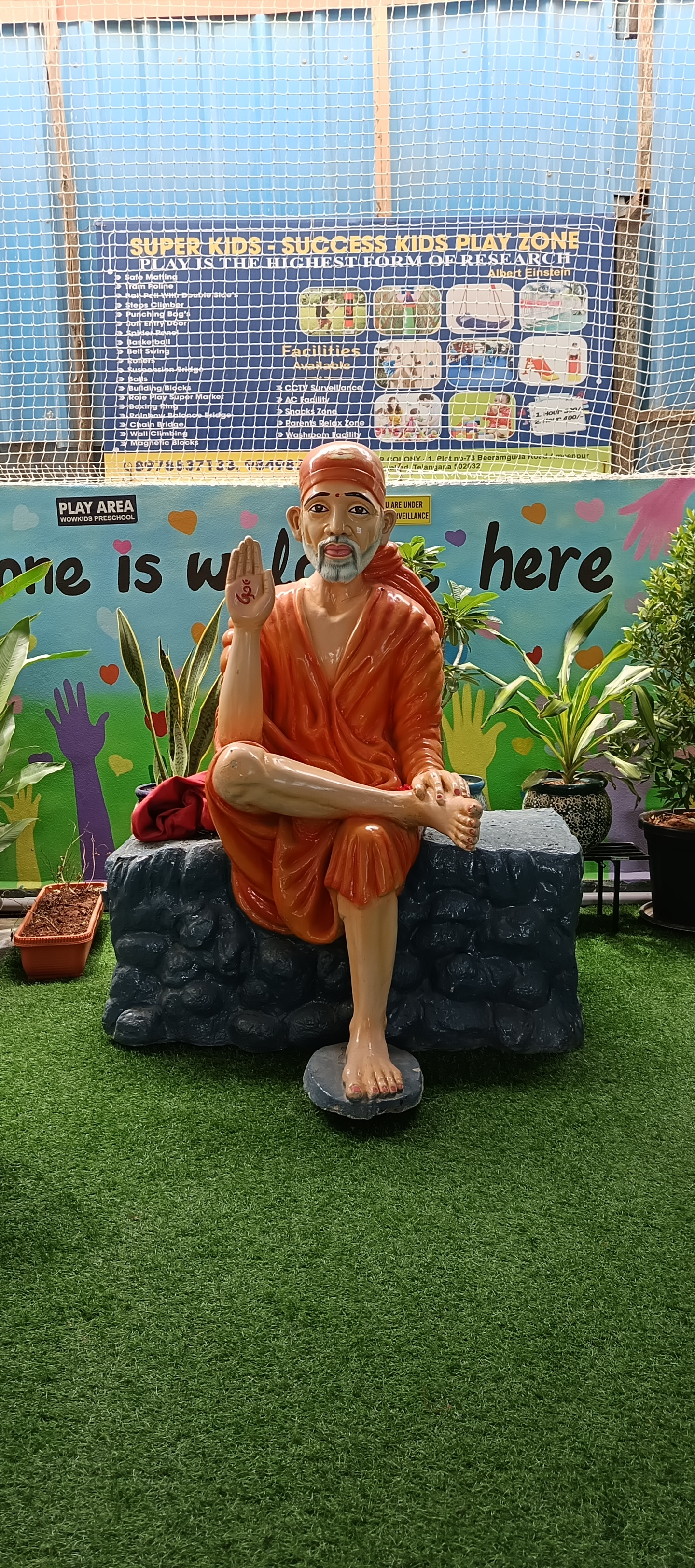 Sai Baba statue in the serene play zone garden area