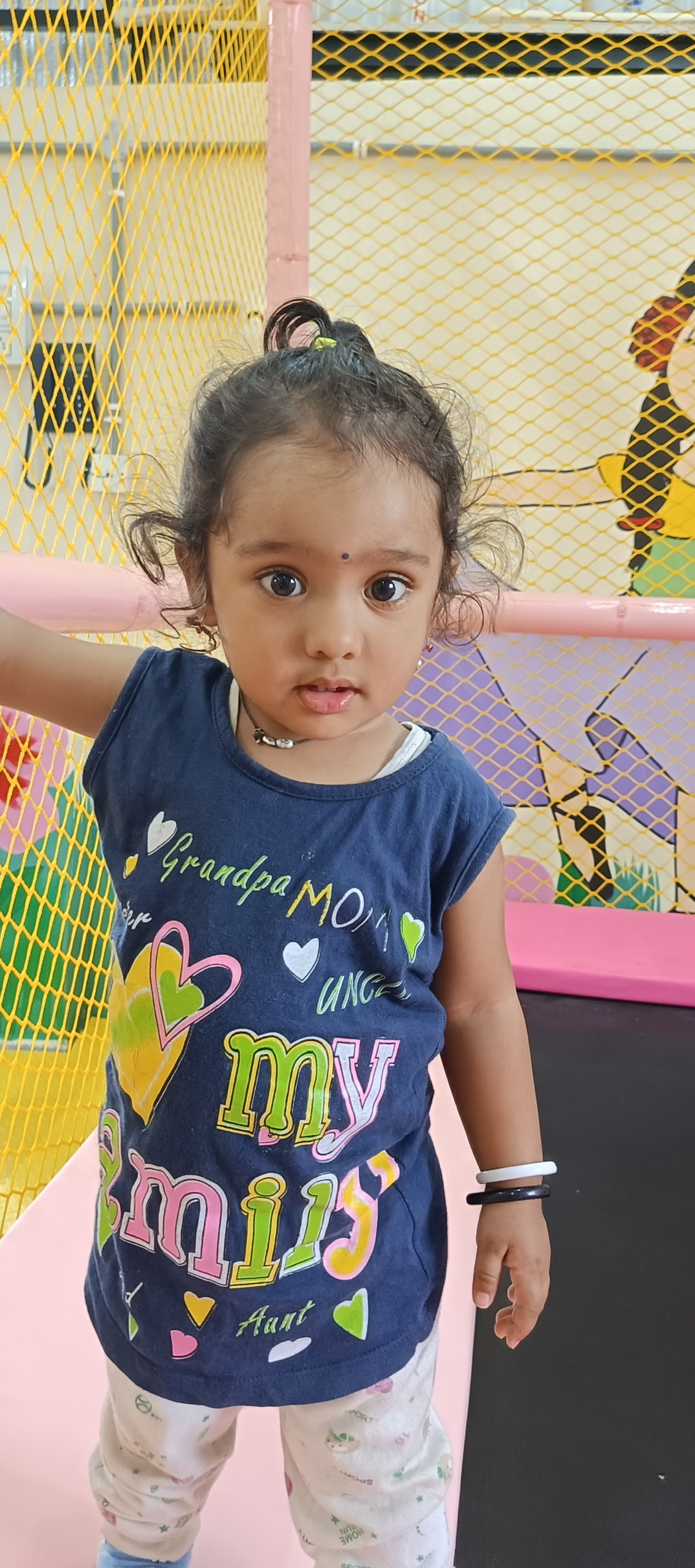 Happy toddler exploring play area equipment