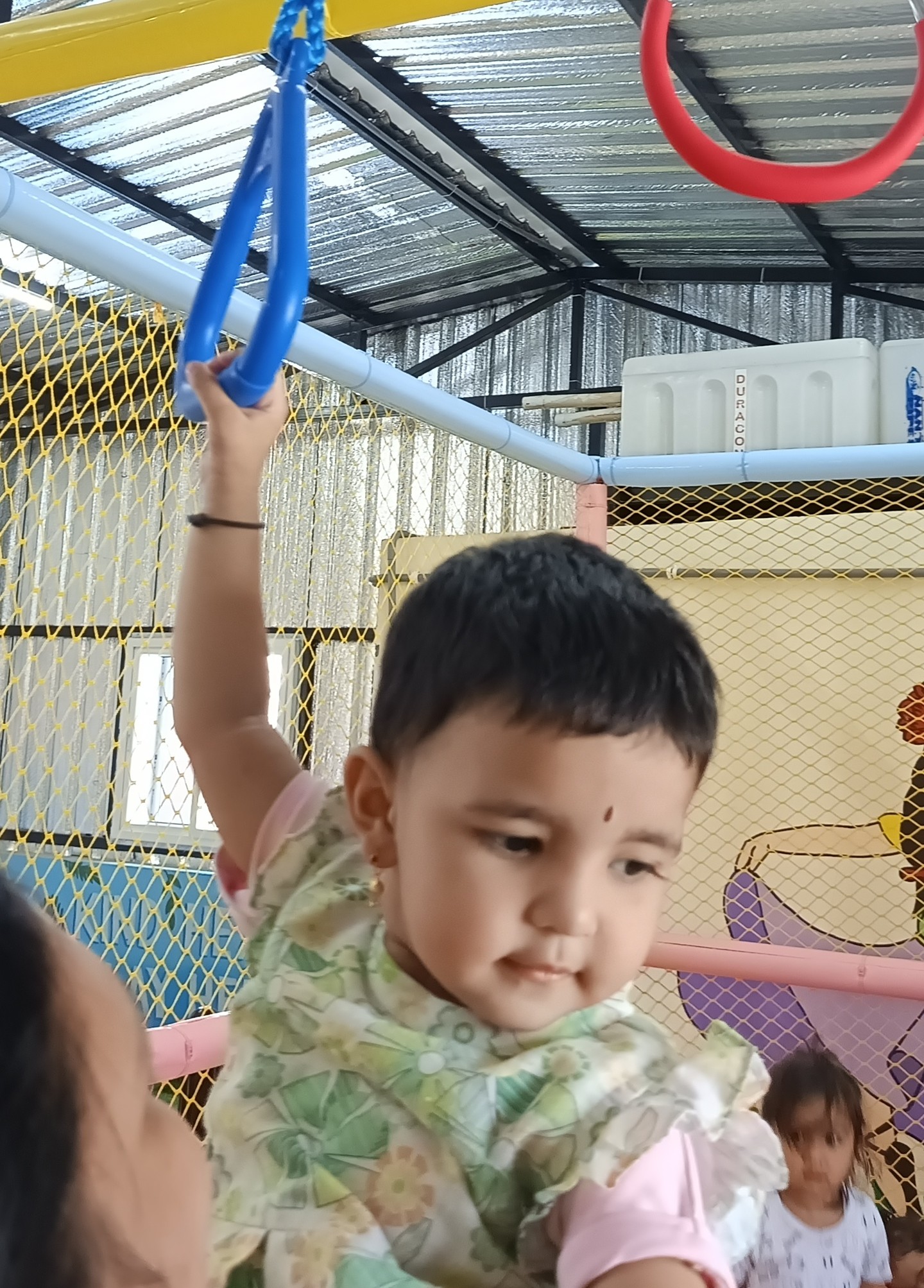 Child reaching for gymnastic ring exercise equipment
