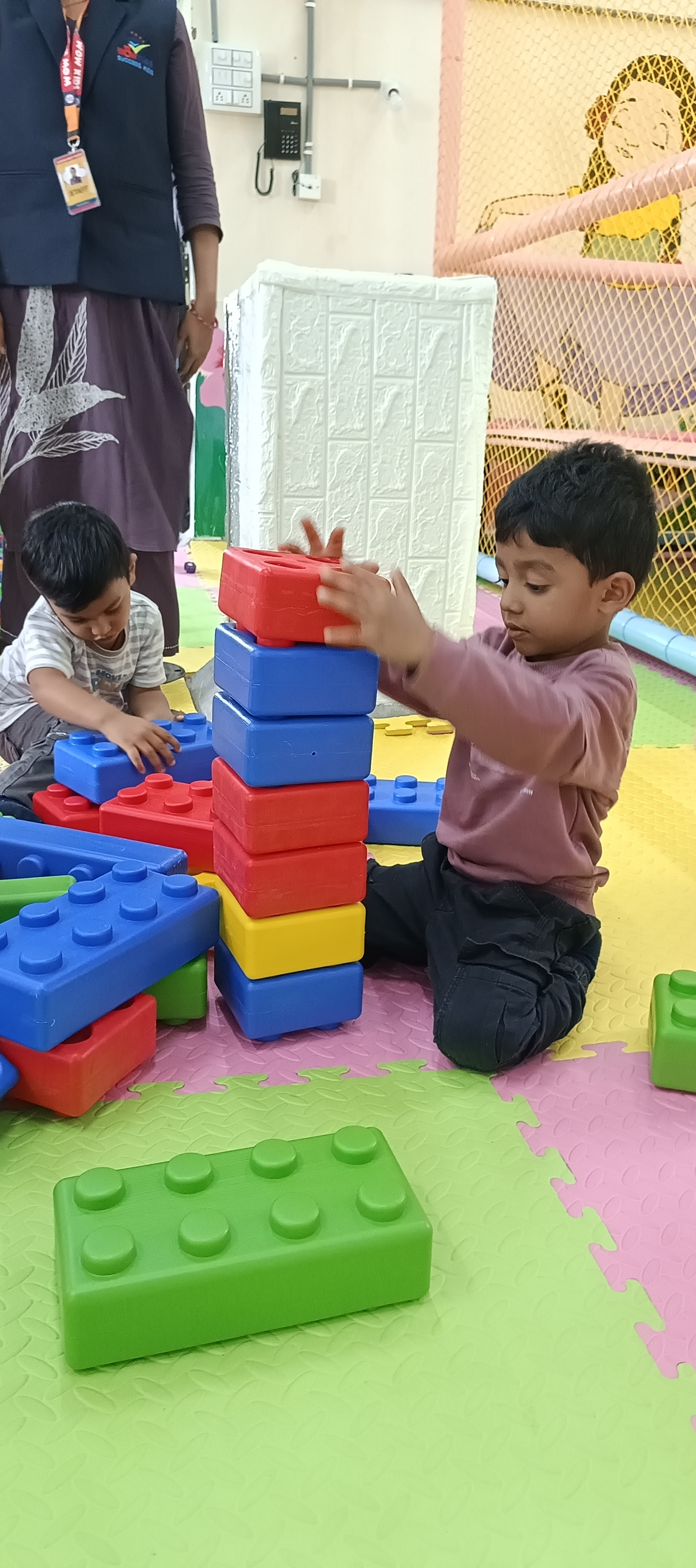 Kids building tall block towers together