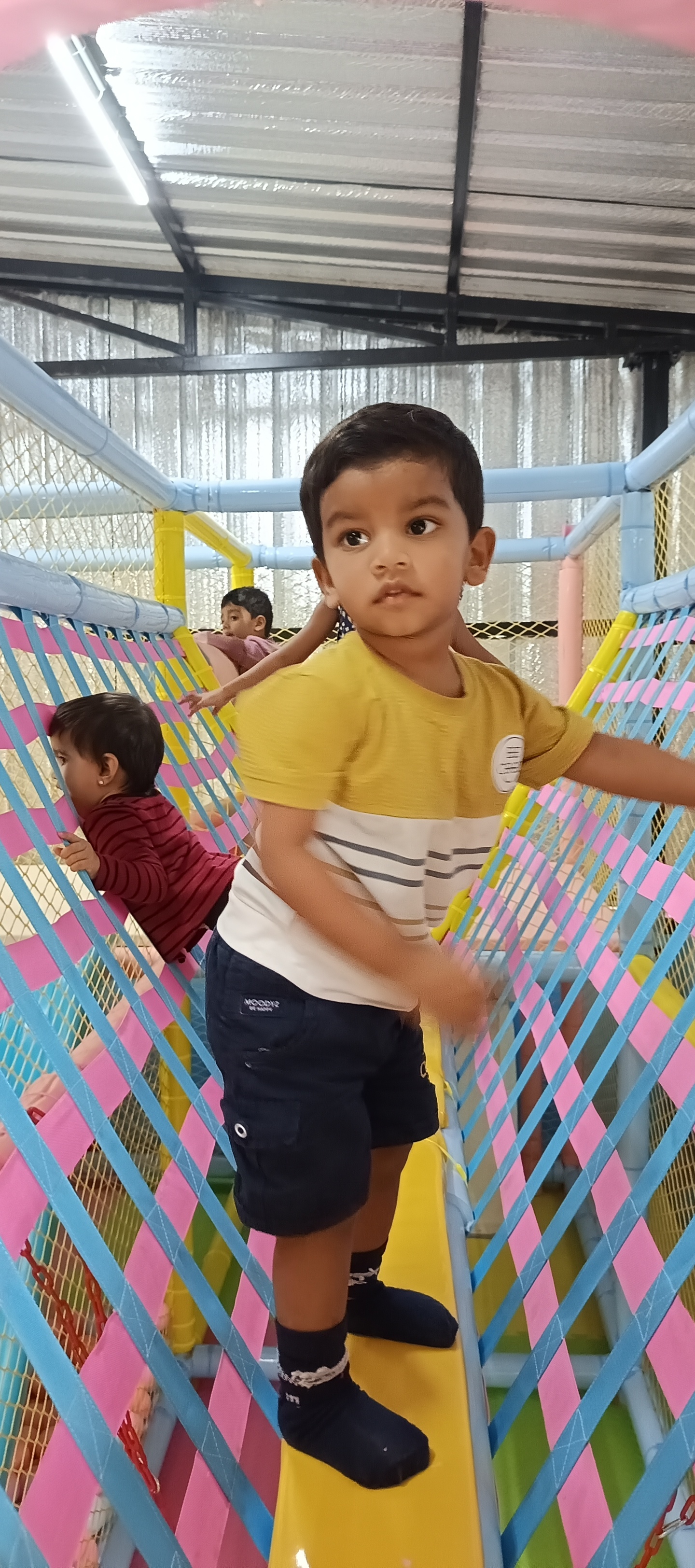 Children navigating net walk obstacle course